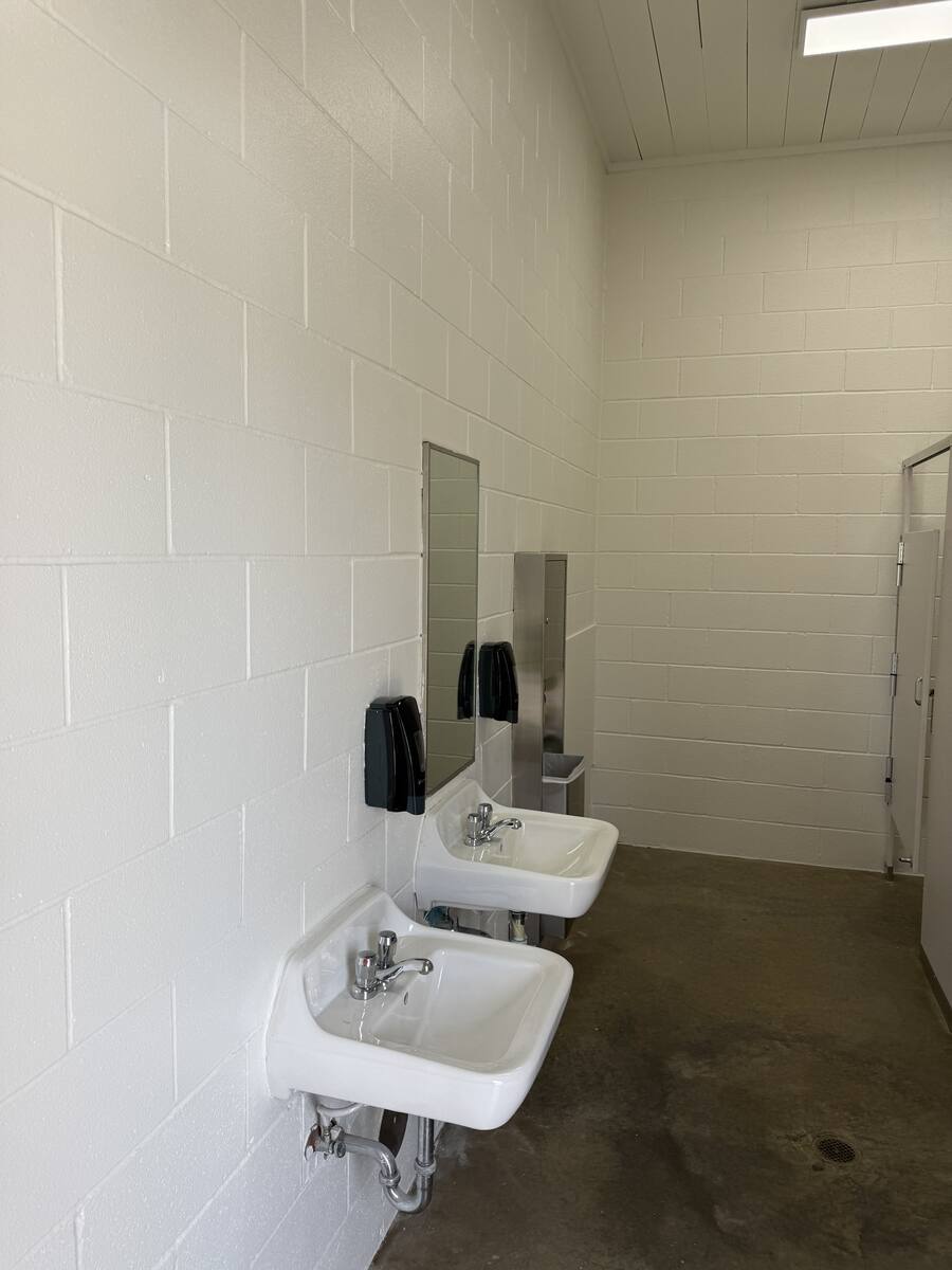 Repainted restroom with clean white CMU walls